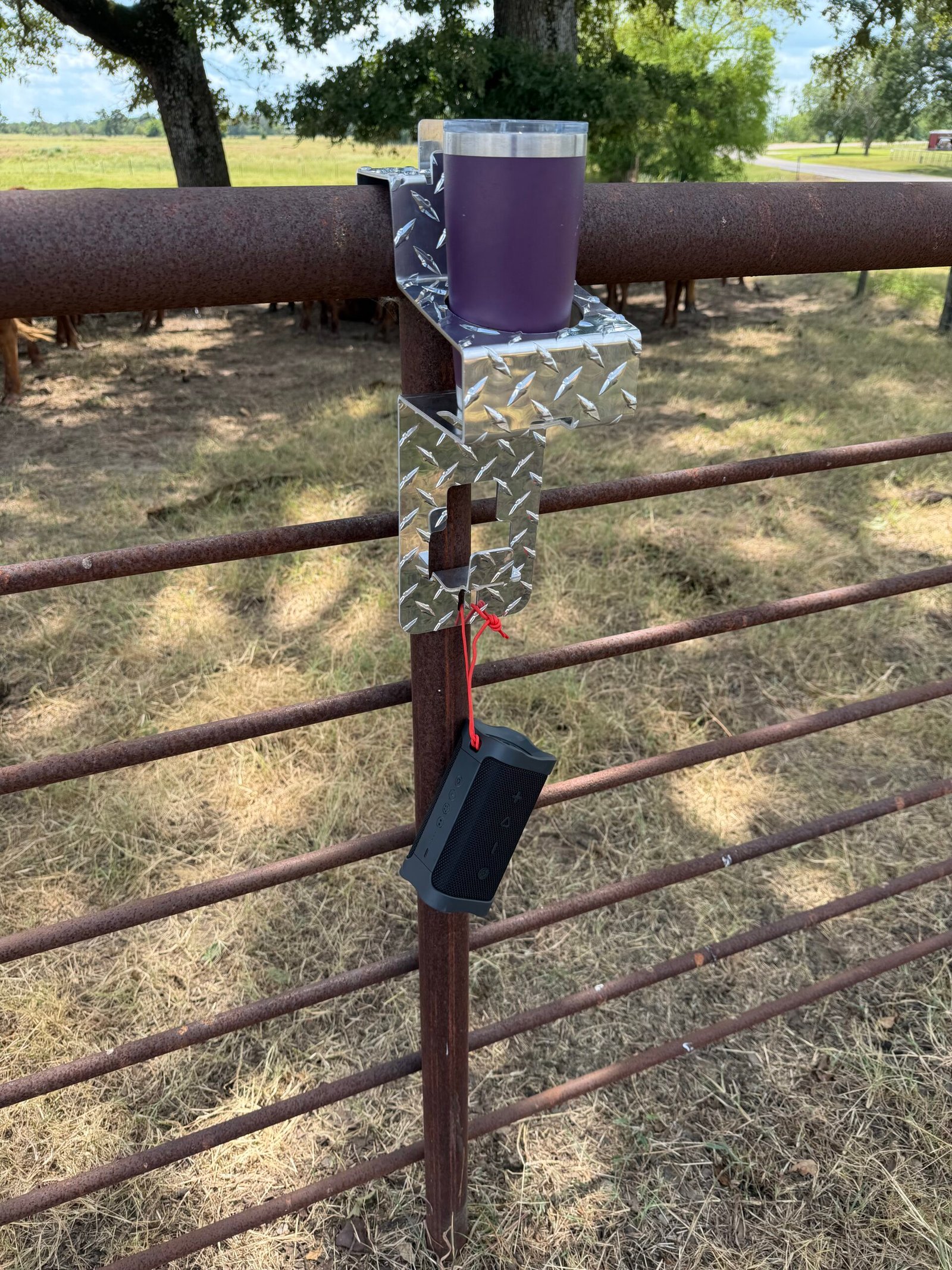DrinkinBuddy with cup in holder and bluetooth speaker hanging from utility hook