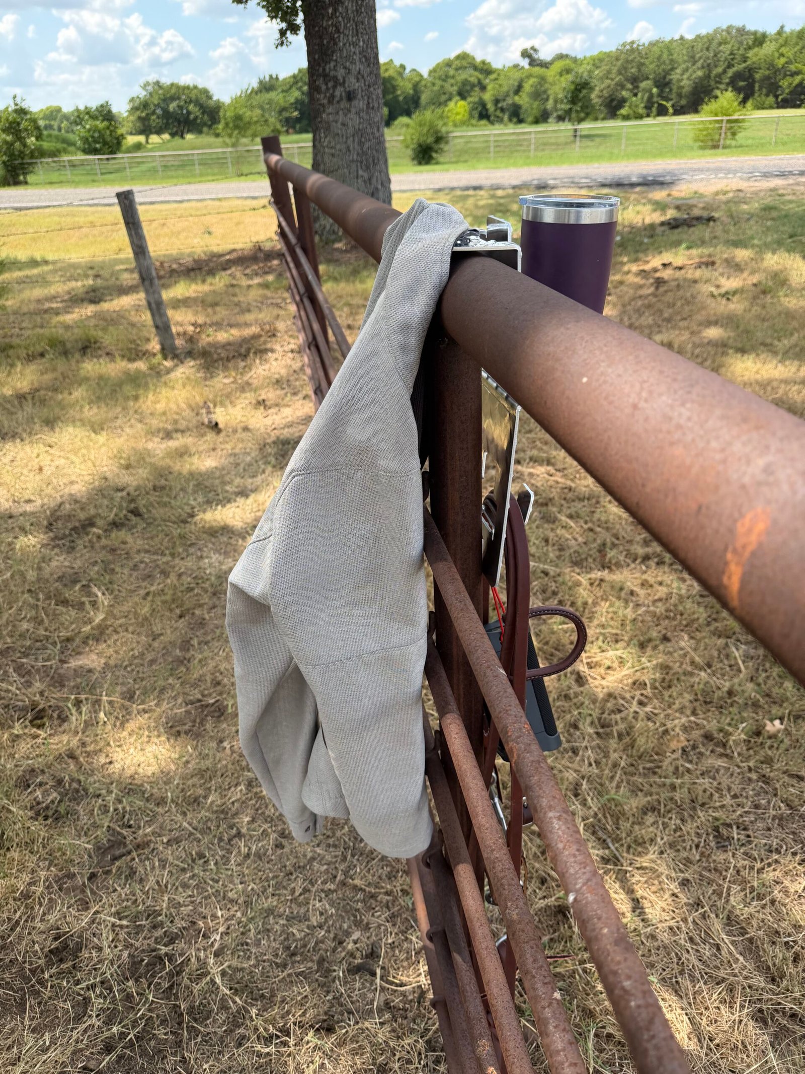 DrinkinBuddy as seen from back side of fence with coat hanging on the coat hook