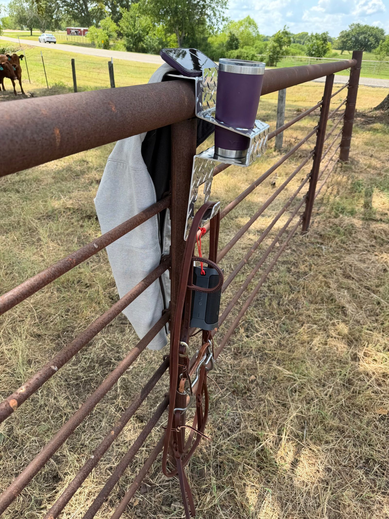 DrinkinBuddy from left side with utility hooks, cup caddie, coat hook, and phone holder in use